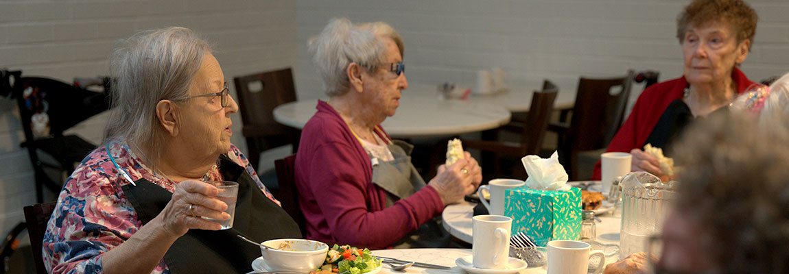 Seniors enjoying a freshly prepared meal in a social and engaging environment.